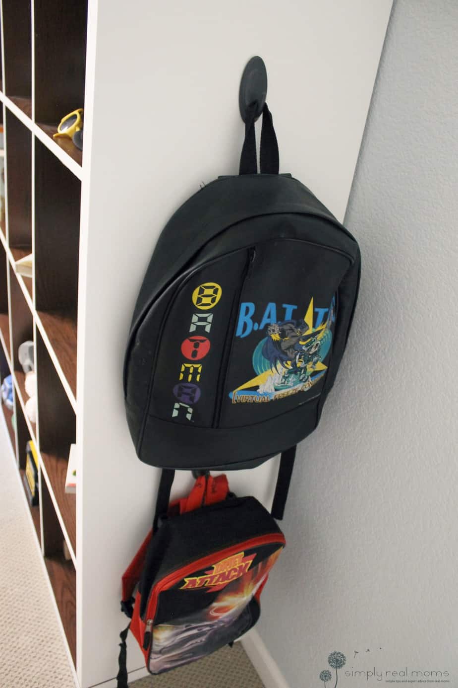 Backpacks hanging on end of the bookshelf