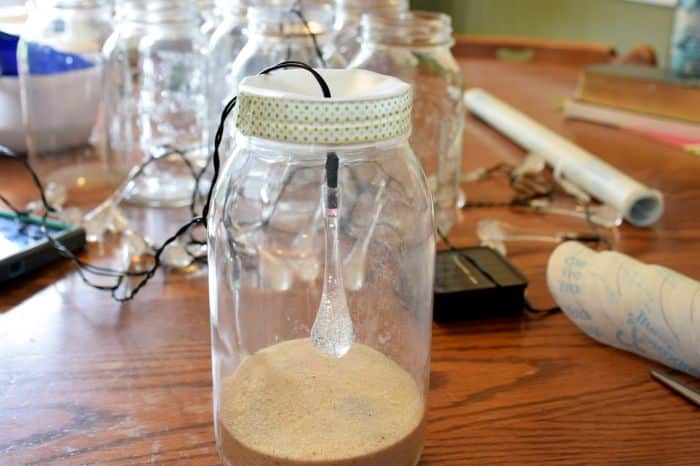 How to make solar powered mason jar lights with with string lighting. Beautiful outdoor mason jar lighting.