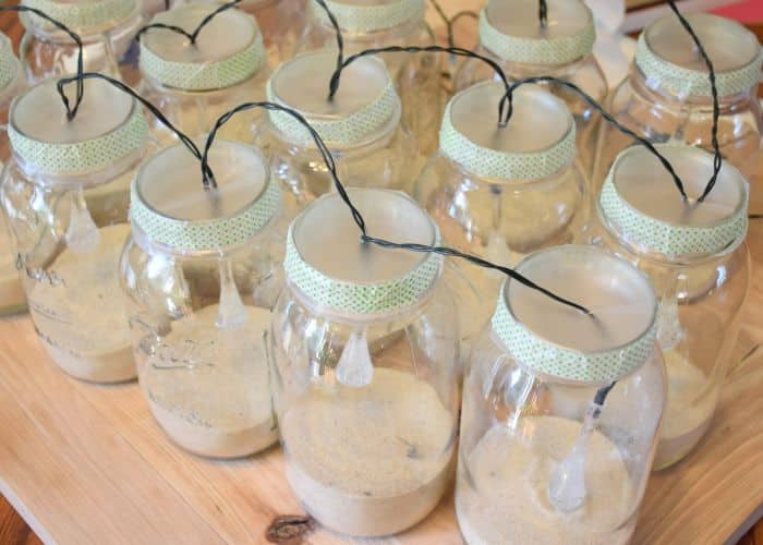 How to make solar powered mason jar lights with with string lighting. Beautiful outdoor mason jar lighting.