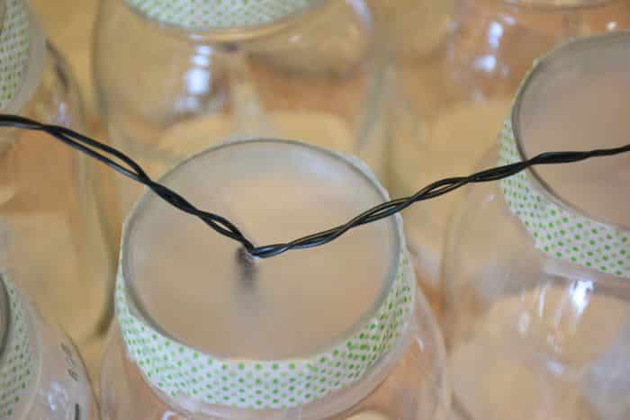 How to make solar powered mason jar lights with with string lighting. Beautiful outdoor mason jar lighting.