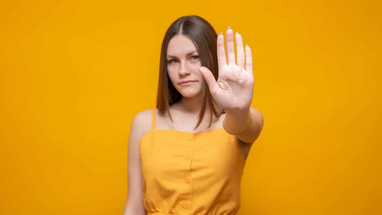 A warning expression with a negative and serious gesture on your face.