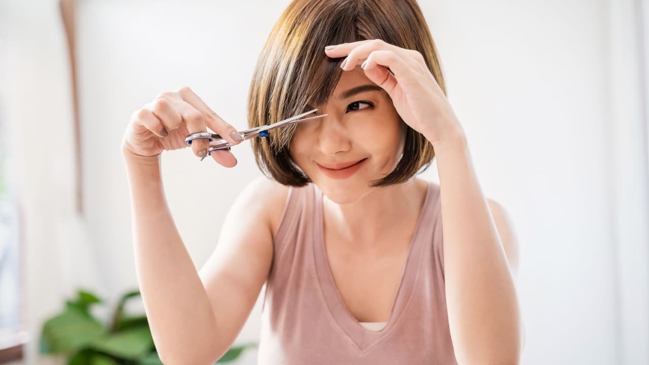 woman cutting her own hair