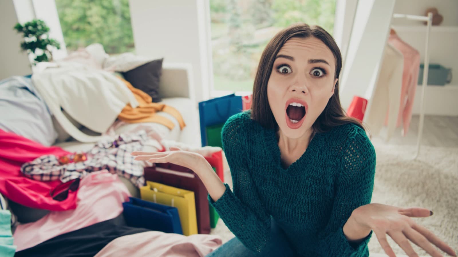 Woman puzzled and confused in messy room