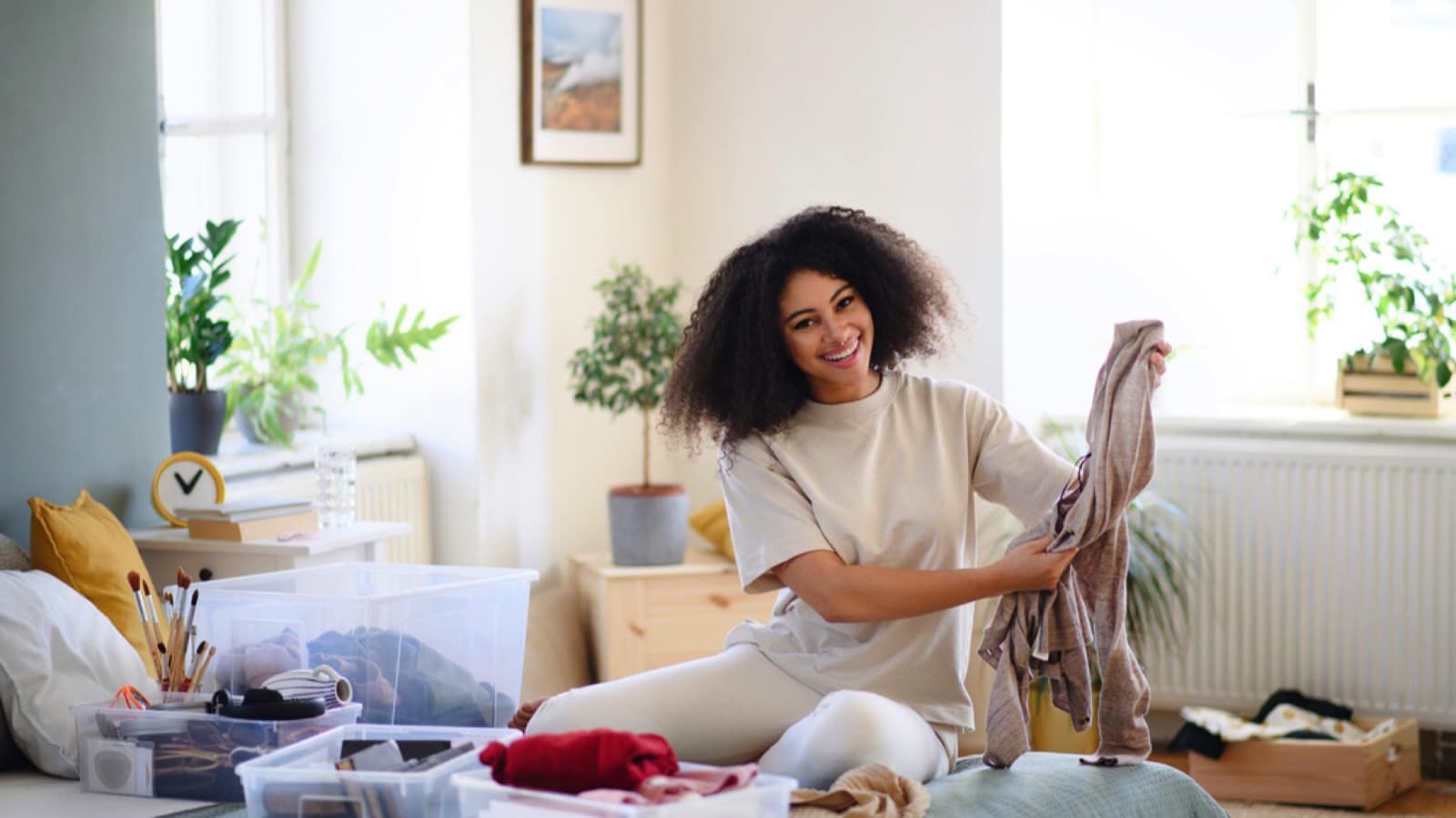 Young woman sorting clothes