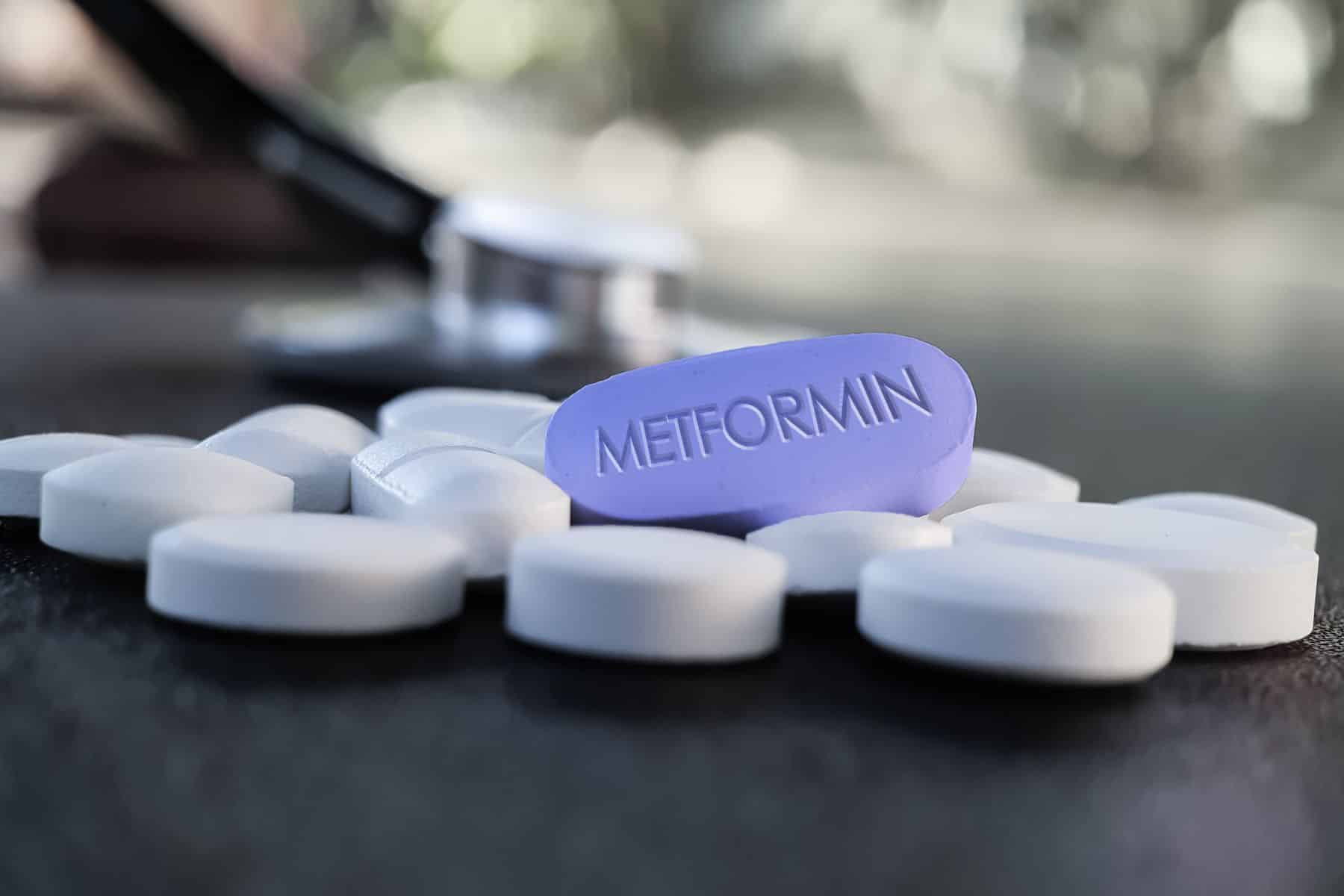Blue Metformin Pill on Table with stethoscope and other tablets in background. Medicine used in standard oral therapy of type 2 diabetes in people who are overweight High Blood Sugar Treatment